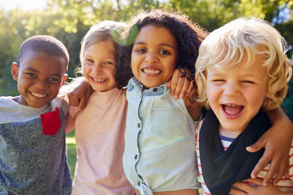 Smiling group of four kids. DPD smiles in St. Charles and Wheaton