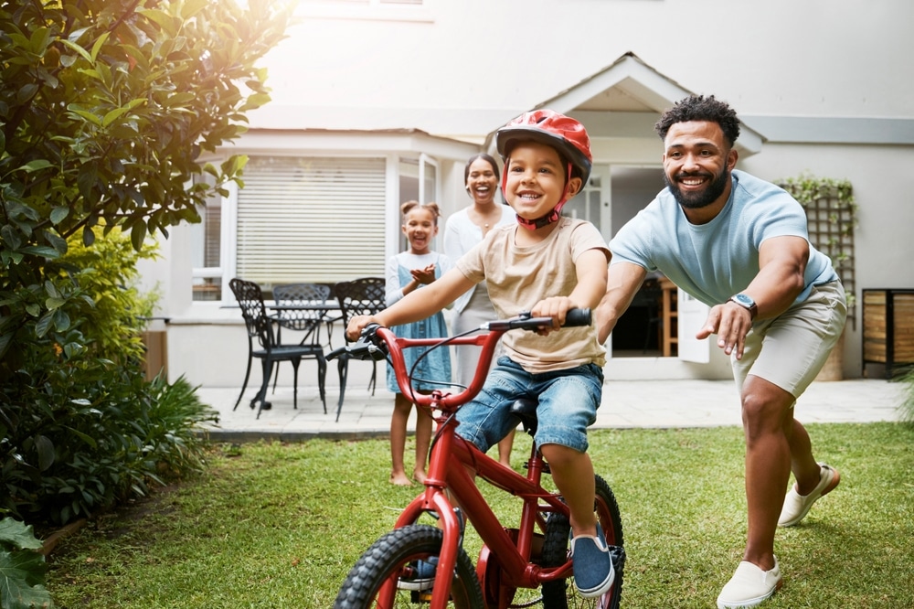 laser dentistry in St. Charles and Wheaton Dad pushing kids on bike