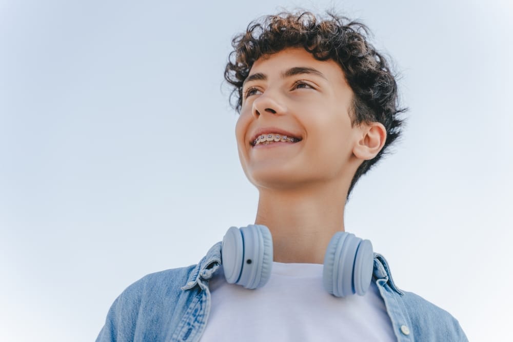 orthodontics for teens in St. Charles and Wheaton. Teen boy smiling with traditional braces in st. charles and wheaton braces in wheaton and st. charles