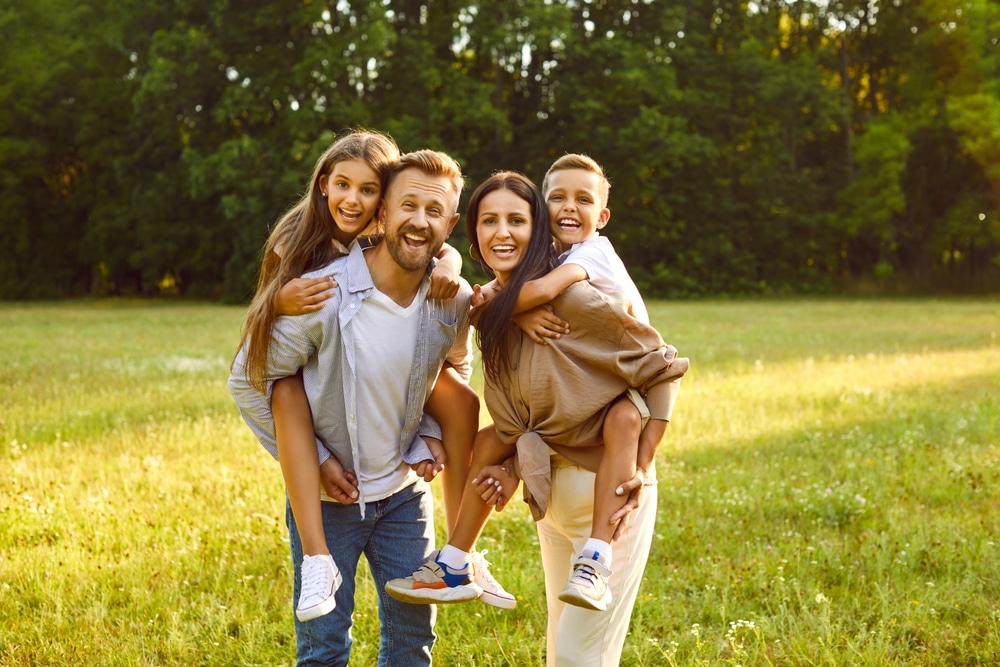 Kids on the back of their parents. dental emergencies in St. Charles and Wheaton